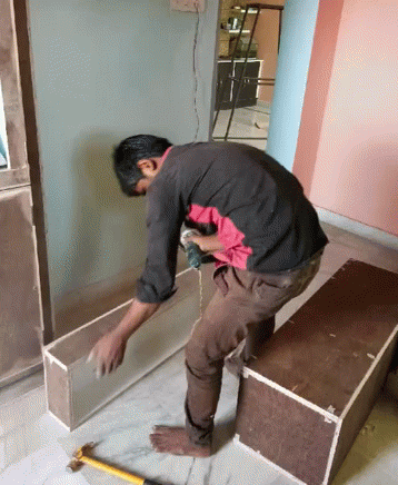 Man Working on Wood With Drill