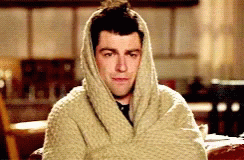 Man Wrapped In Blanket Looking At Camera GIF