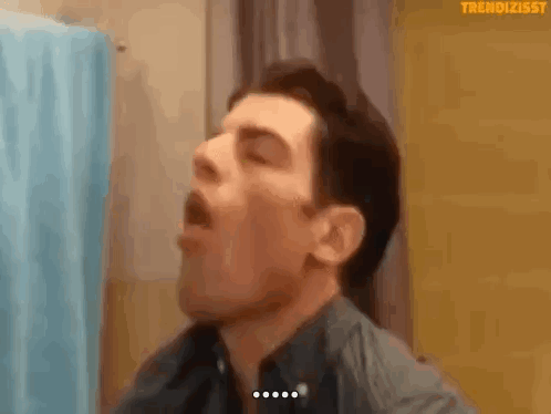 Man Yawning in Front of Mirror