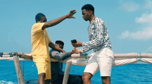 Man Yellow Shirt High Fives Man White Shorts