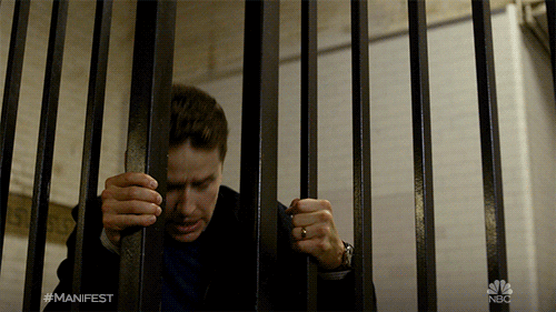 Manifest Railing Hold Behind Bars GIF