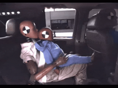 Mannequin In Suit And Tie Sitting In Back Seat Of Vehicle GIF