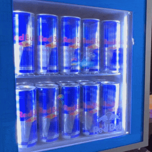 Many Cans Of Red Bull Are Lined Up In A Cooler GIF