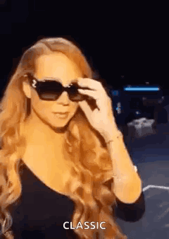 Mariah Carey Wearing Sunglasses and Black Dress