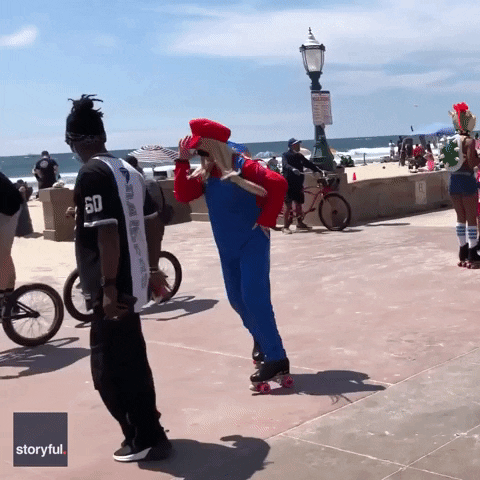 Mario Cosplayer Dancing Backwards In Roller Blades GIF