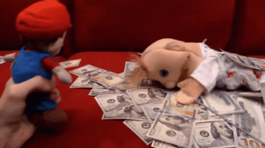 Mario Looking To Puppet Laying On Cash GIF