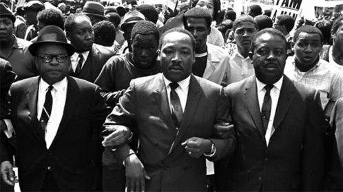 Martin Luther King Jr. Escorted by Men in Suits
