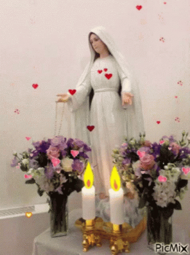 Mary Statue Surrounded by Flowers and Candles