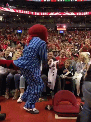 Mascot Dancing In Front Of Welcome Sign GIF