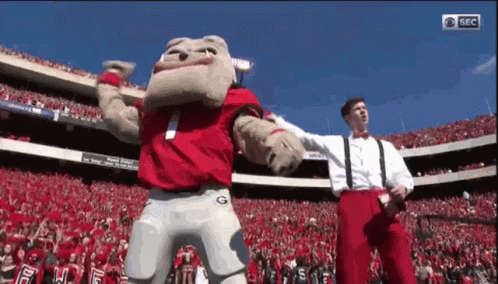 Mascot Dancing In Stadium With Two Men GIF
