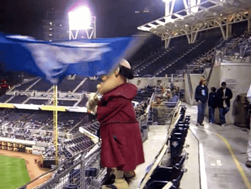 Mascot Holding Flag in Baseball Stadium