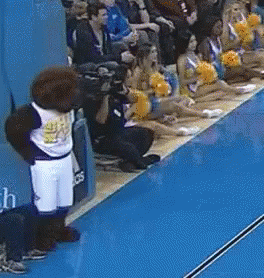 Mascot in Front of Cheerleaders With Pom Poms