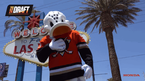 Mascot In Front Of Welcome To Las Vegas Sign GIF