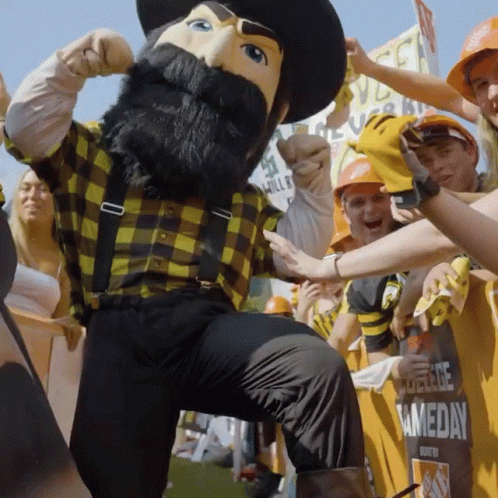 Mascot in Plaid Shirt and Suspenders in Crowd