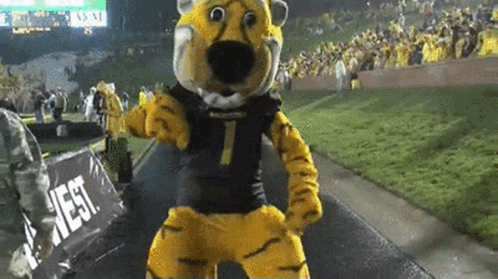 Mascot in Tiger Costume Dancing in Front of West Sign