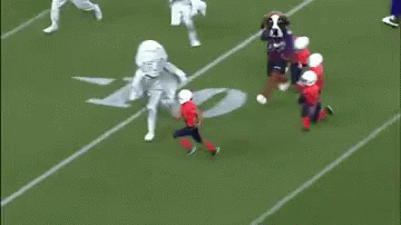 Mascot on Football Field With Referee