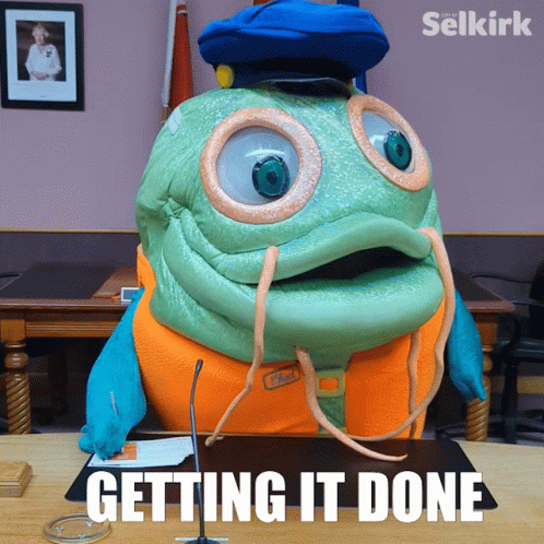 Mascot Sitting At Desk Getting It Done GIF