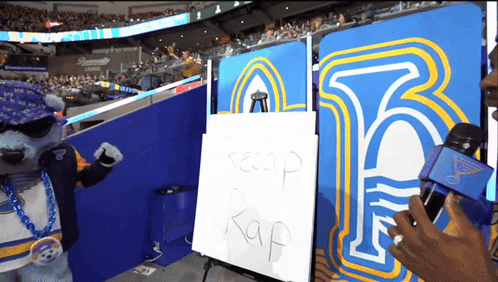 Mascot Standing In Front Of Keep Rap Sign GIF
