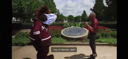 Mascot Wearing Mask Talks to Man in Park
