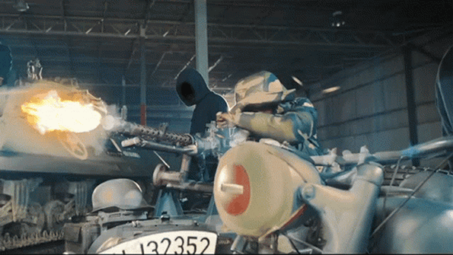 Mask Man Firing The Machine Gun GIF