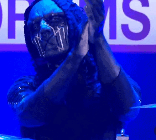 Masked Man Clapping Drums Sign