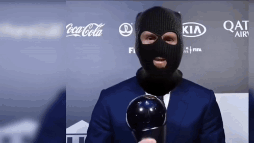 Masked Man Holding Trophy Coca-Cola Kia Qatar Air