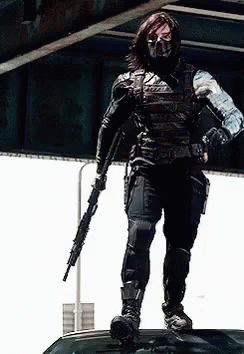 Masked Man on Car Roof Holding Gun