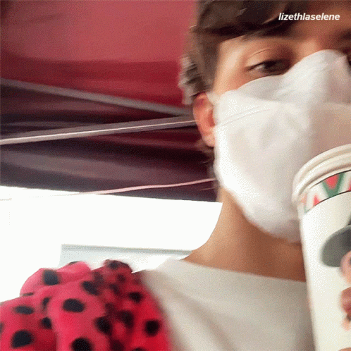 Masked Person Holding Coffee Cup With Name Lizethlaselene
