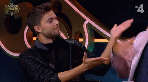 Masked Singer Man Talking to Woman