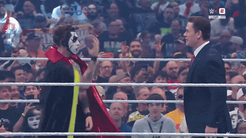 Masked Suited Men Talk in Wrestling Ring W