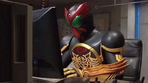 Masked Superhero Sitting At Computer GIF