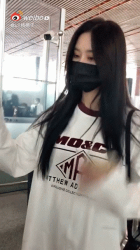 Masked Woman in White Shirt with M & C