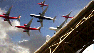 Mass Airplanes Flying Above Bridge GIF