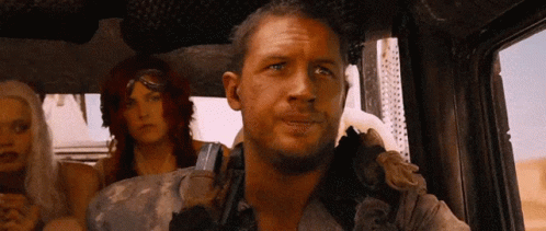 Max Rockatansky Of Mad Max Fury Road Pointing Above While Driving GIF