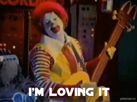 Mcdonald 'S Clown Playing A Guitar With The Words I 'M Loving It Below Him GIF