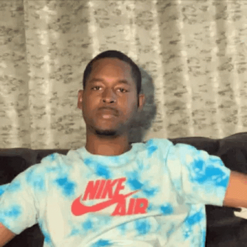 Mean Mug Look Of Man Sitting Down GIF