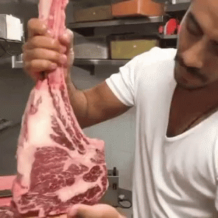 Salt Bae Showing The Marbled Of Tomahawk Meat GIF
