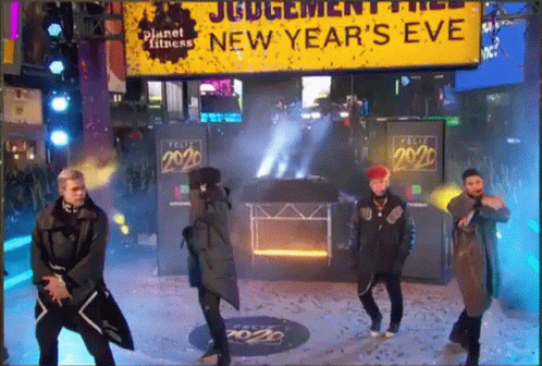 Men Dancing In Front Of New Year's Eve Sign GIF
