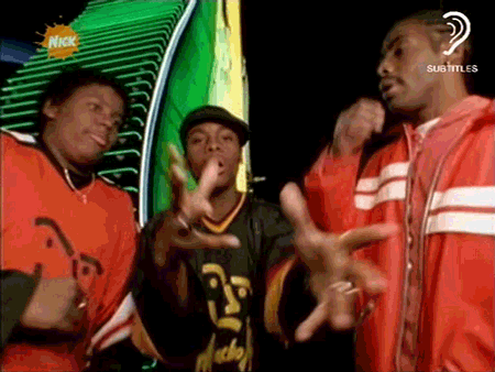 Men Dancing in Front of Nickelodeon Sign