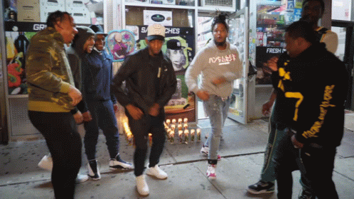 Men Dancing in Front of Store Saying gr