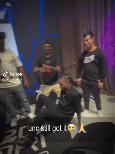 Men Dancing In Front Of TikTok Sign GIF
