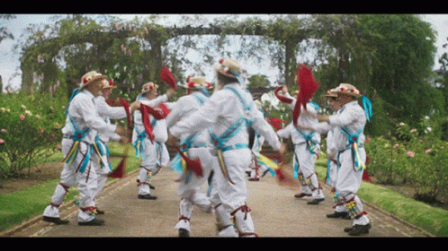 Men Dancing In Garden Path GIF