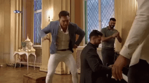 Men Dancing in Room With Stained Glass Window