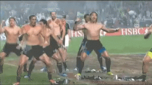 Men Dancing on Soccer Field with Seven Sign