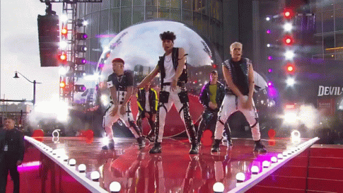 Men Dancing On Stage Under Devil Sign GIF