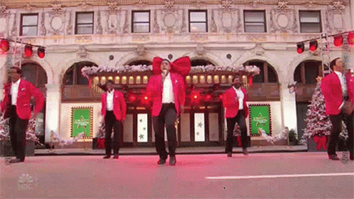 Men Dancing Outside Large Building