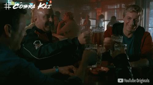 Men Drinking Beer At Table With YouTube Originals Ad GIF