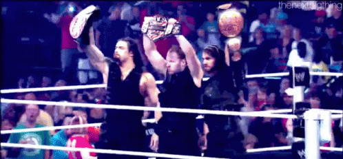 Men Holding Championship Belts In Wrestling Ring GIF