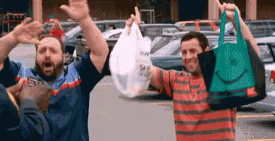 Men Holding Shopping Bags and Celebrating