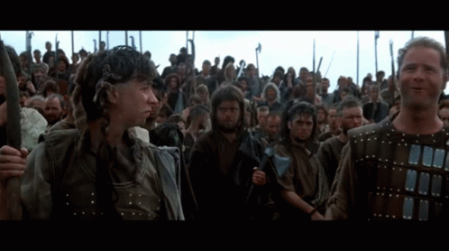 Men Holding Spears In Front Of Crowd GIF